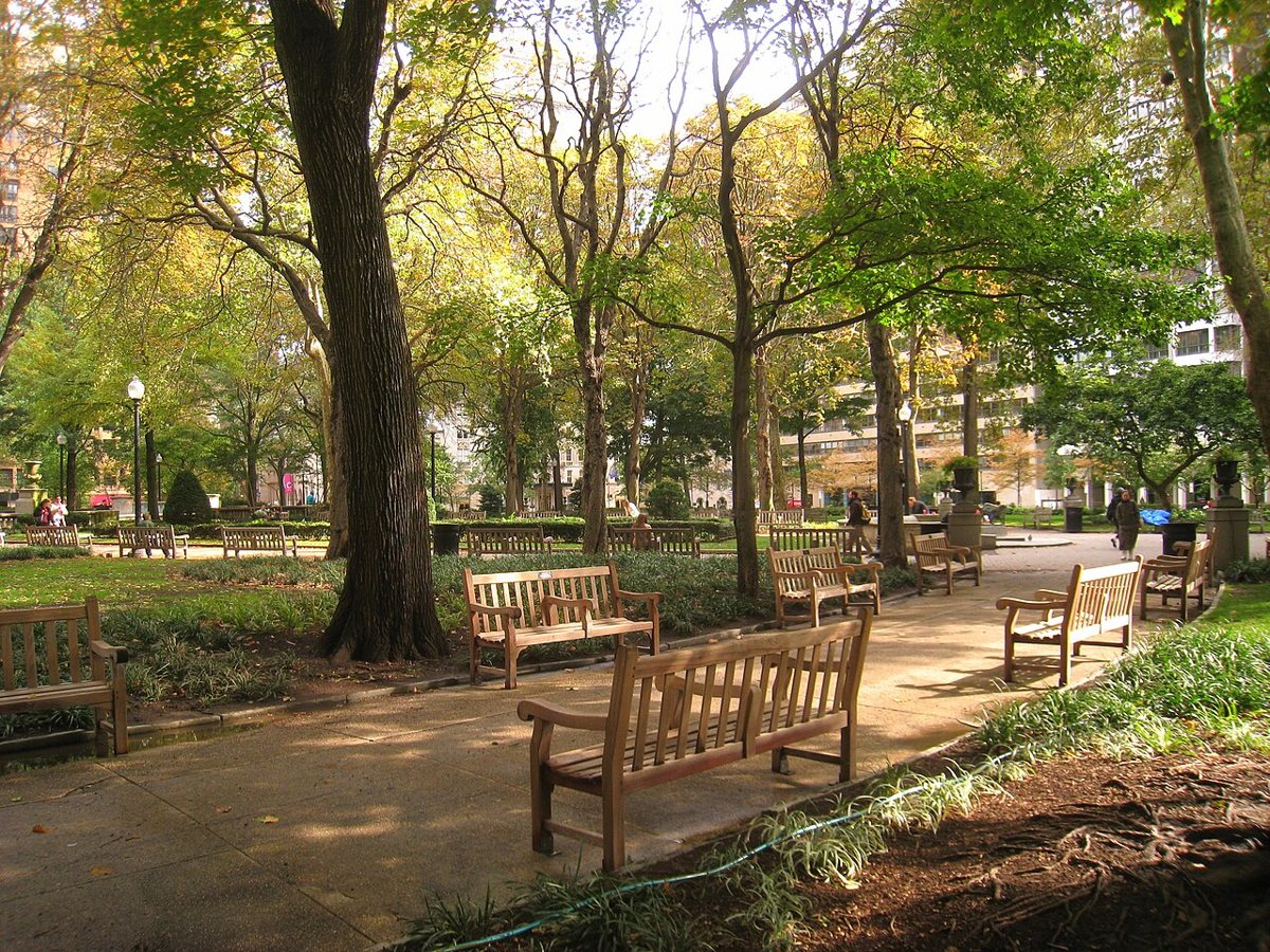 People relaxing under the trees in Rittenhouse Square in Philadelphia